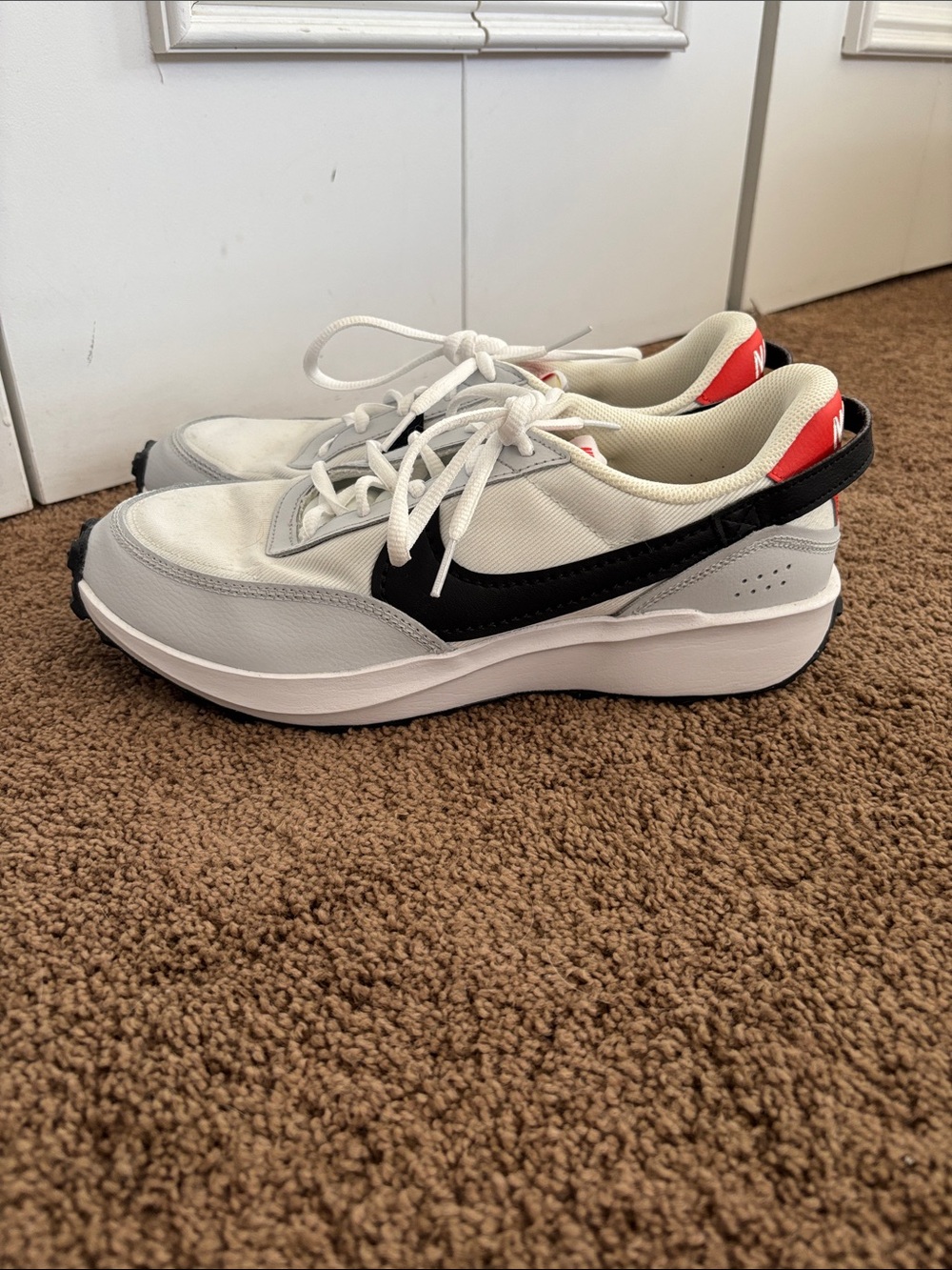 Nike Waffle Debut sneakers in a white, black, and picante red colorway.